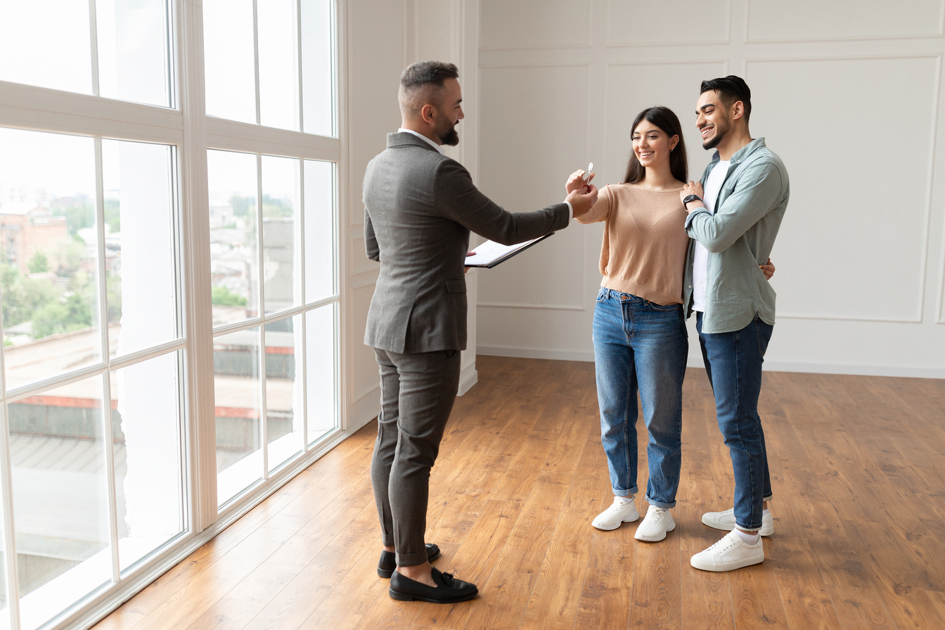 Real Estate Agent Giving Keys to Excited Buyers